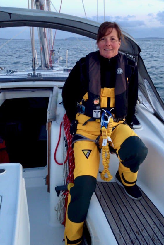 woman on sailboat in foul weather gear